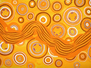 detail of Aboriginal artwork in the dots stylt using yellows and oranges